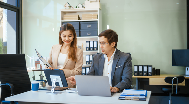 Office to people looking at a laptop