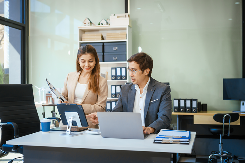 Office to people looking at a laptop